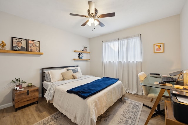 bedroom with ceiling fan and wood-type flooring