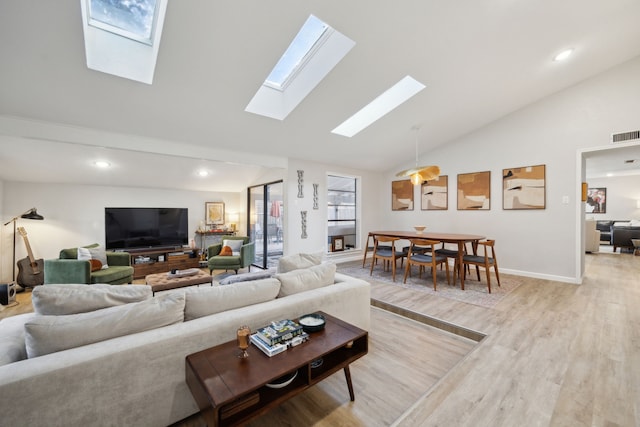 living room with high vaulted ceiling and light wood-type flooring