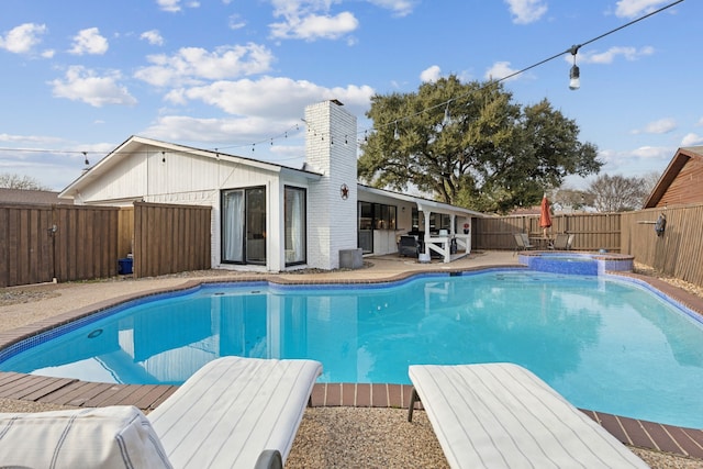 view of swimming pool with an in ground hot tub and a patio