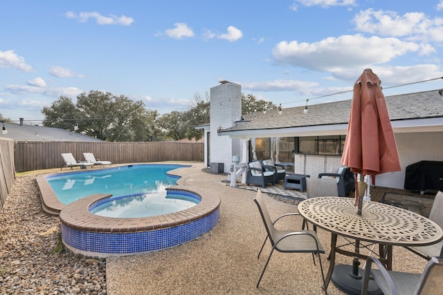 view of pool featuring an outdoor living space, grilling area, a patio, and an in ground hot tub