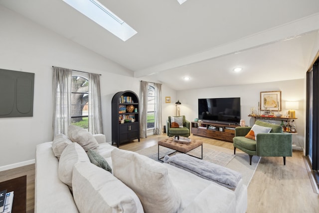 living room with lofted ceiling with skylight and light wood-type flooring