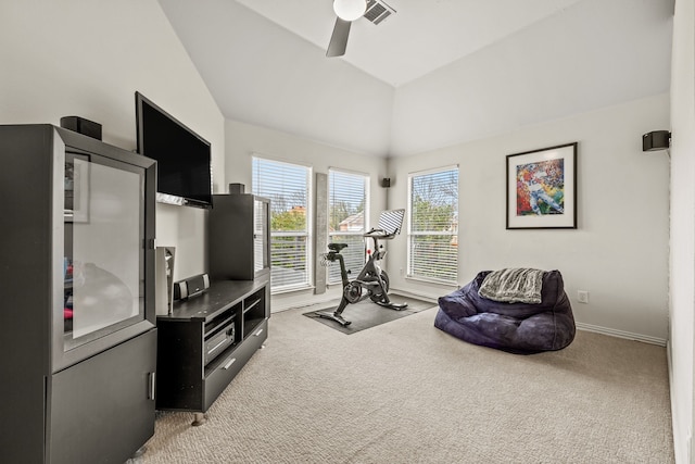 exercise area featuring light carpet, visible vents, vaulted ceiling, and a ceiling fan