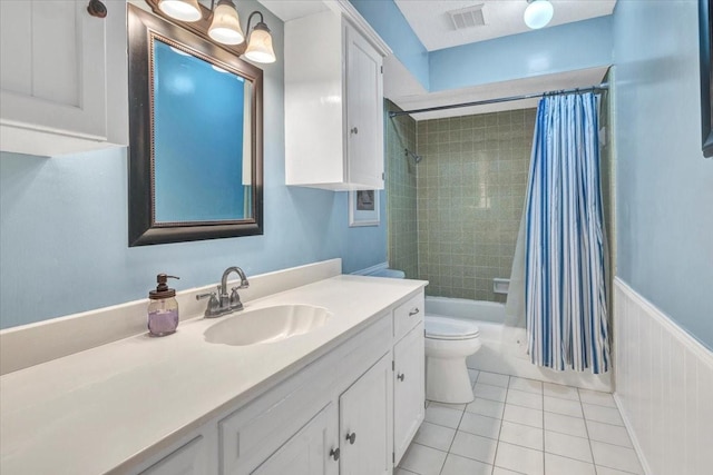 full bathroom featuring vanity, shower / tub combo with curtain, tile patterned floors, and toilet