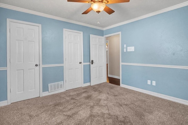 unfurnished bedroom featuring ornamental molding, ceiling fan, and carpet flooring