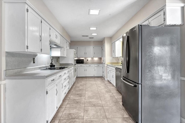 kitchen featuring white cabinetry, light tile patterned floors, black appliances, and sink