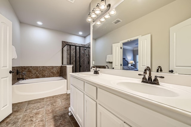 bathroom with tile patterned floors, vanity, and shower with separate bathtub