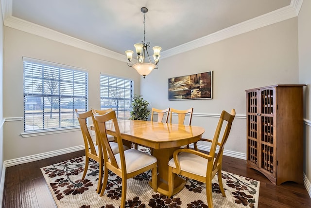 dining space featuring dark wood-type flooring, ornamental molding, and a chandelier