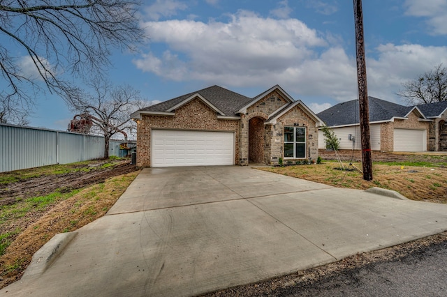 view of front facade featuring a garage, brick siding, concrete driveway, and a shingled roof
