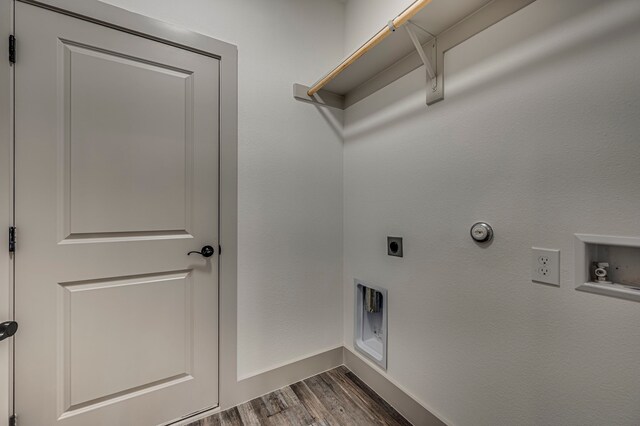 clothes washing area with washer hookup, hookup for a gas dryer, laundry area, hookup for an electric dryer, and dark wood-style flooring