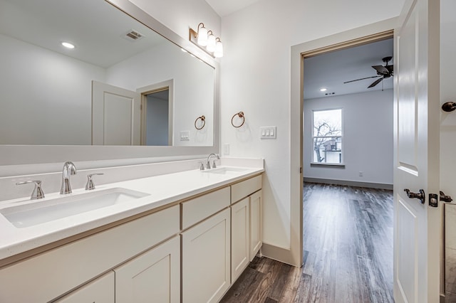 bathroom featuring vanity, wood-type flooring, and ceiling fan