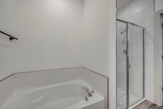 full bath featuring a bath and a stall shower