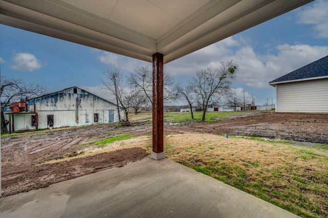 view of yard with an outbuilding and a patio area