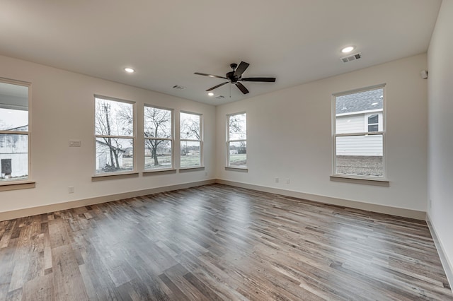 spare room featuring visible vents, recessed lighting, ceiling fan, and wood finished floors