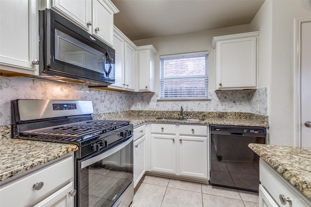 kitchen featuring sink, black appliances, light stone countertops, white cabinets, and decorative backsplash