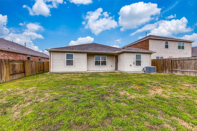 rear view of property with a yard