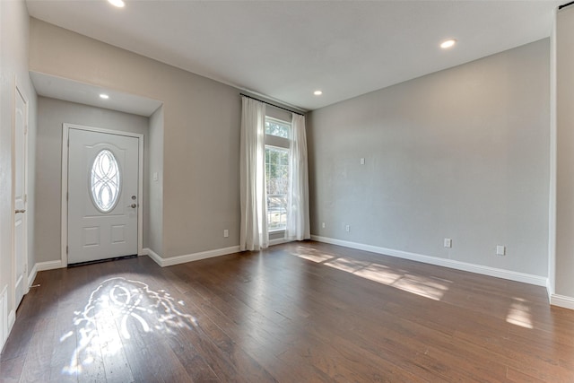 foyer with hardwood / wood-style floors, baseboards, and recessed lighting