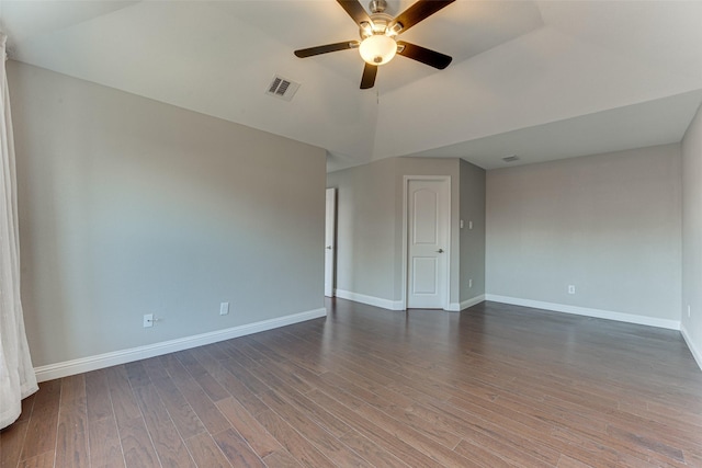 unfurnished room featuring ceiling fan, lofted ceiling, and dark hardwood / wood-style flooring