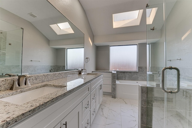 bathroom with independent shower and bath, vanity, a healthy amount of sunlight, and lofted ceiling with skylight