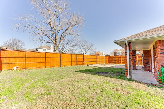 view of yard with a patio and a fenced backyard