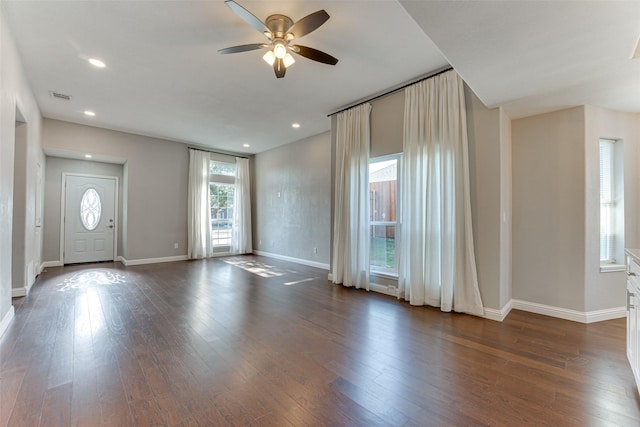 interior space featuring dark wood-type flooring and ceiling fan