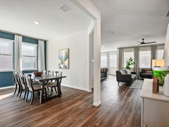 dining space with dark wood-type flooring and ceiling fan