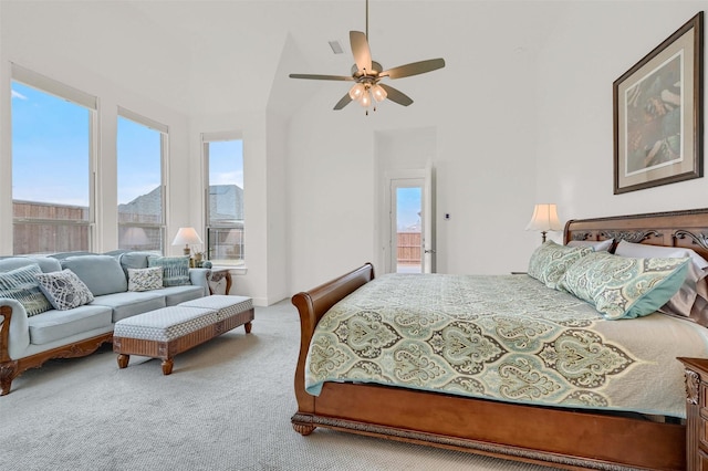 carpeted bedroom featuring ceiling fan and a towering ceiling