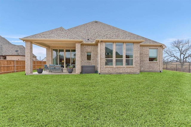 back of house with a yard and a patio area