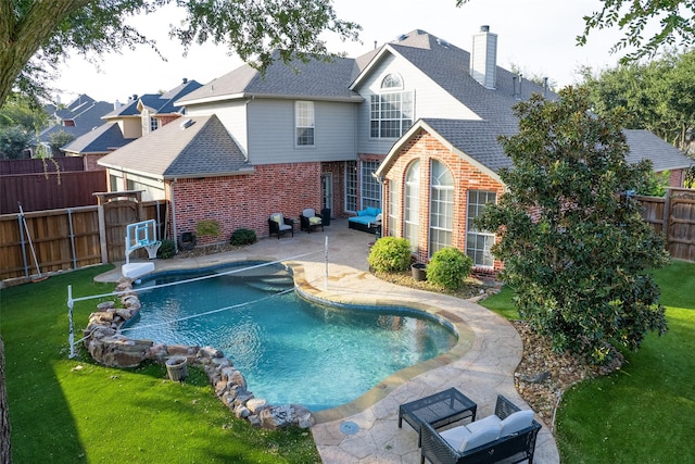 view of swimming pool with a yard and a patio