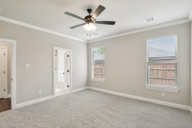 unfurnished bedroom with carpet flooring, visible vents, and ornamental molding