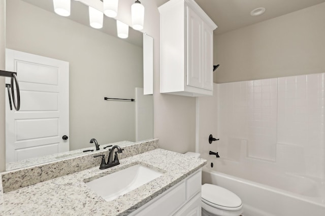 bathroom featuring vanity, shower / bath combination, and toilet