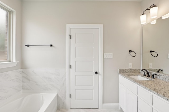 full bathroom with a garden tub and vanity