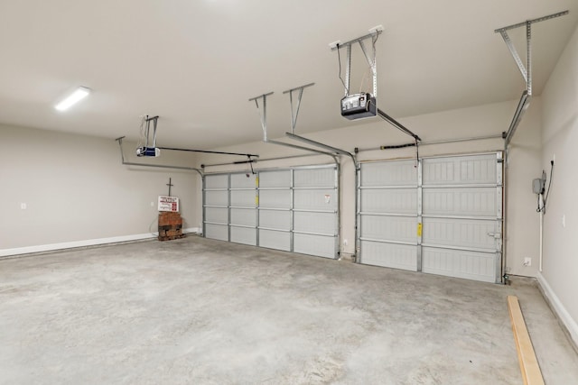 garage with baseboards and a garage door opener
