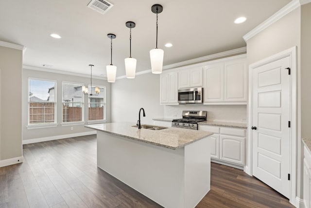 kitchen featuring visible vents, a sink, ornamental molding, and stainless steel appliances