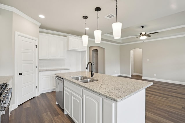 kitchen with a ceiling fan, dark wood-type flooring, arched walkways, a sink, and appliances with stainless steel finishes