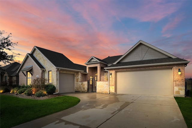 view of front of house with a garage and a yard