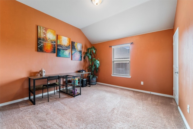 carpeted office featuring lofted ceiling