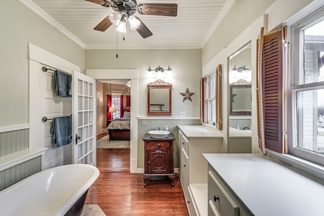 bathroom featuring vanity, a bathtub, ornamental molding, and hardwood / wood-style flooring