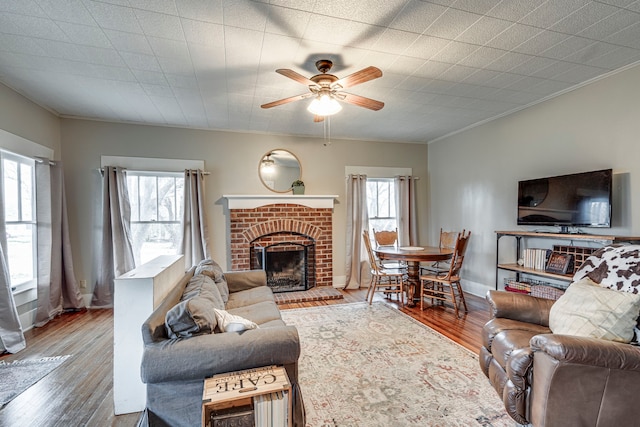 living room with hardwood / wood-style flooring, crown molding, and a wealth of natural light