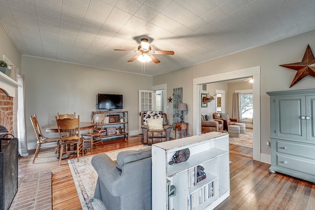 living room with ceiling fan and light hardwood / wood-style floors