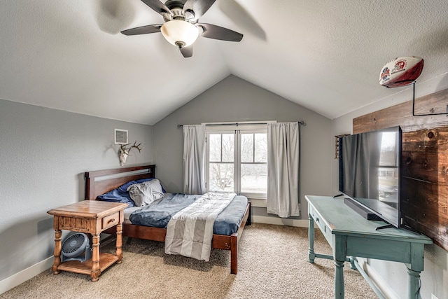 carpeted bedroom featuring lofted ceiling, ceiling fan, and a textured ceiling