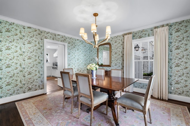 dining area with crown molding, hardwood / wood-style floors, and a chandelier