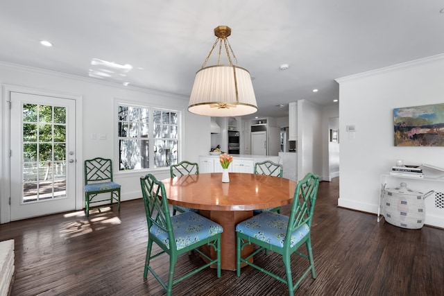 dining room featuring ornamental molding and dark hardwood / wood-style floors