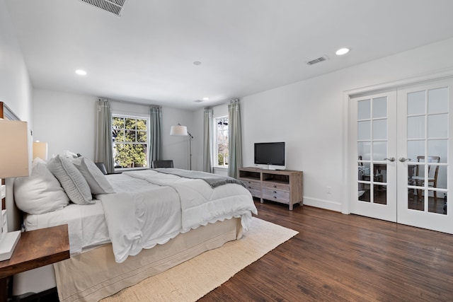 bedroom featuring dark hardwood / wood-style flooring and french doors