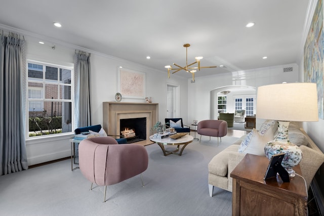 living room featuring ornamental molding, plenty of natural light, and a chandelier