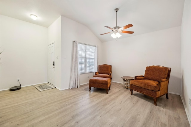 living area featuring vaulted ceiling, ceiling fan, and light hardwood / wood-style floors