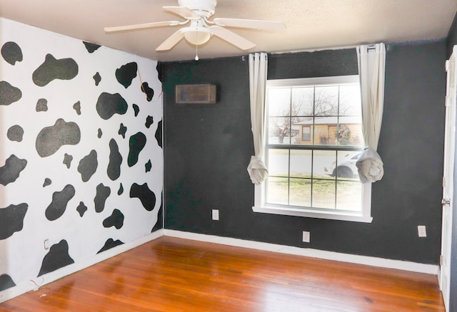 spare room featuring ceiling fan and hardwood / wood-style floors