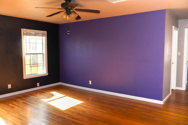 spare room featuring ceiling fan and hardwood / wood-style floors