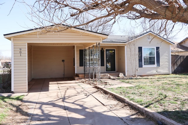 ranch-style house featuring a carport