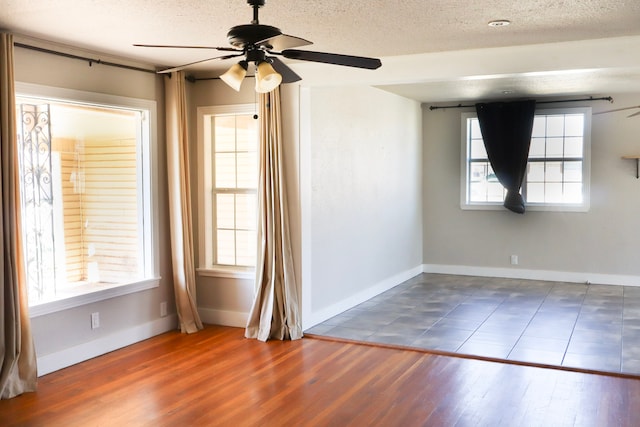 unfurnished room with hardwood / wood-style floors, a textured ceiling, and ceiling fan