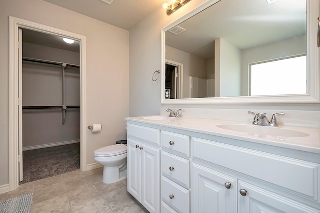 bathroom featuring vanity, tile patterned floors, and toilet